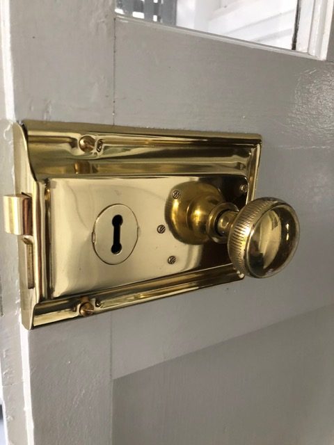 Restored brass knob and keyhole escutcheon on a Brisbane heritage door