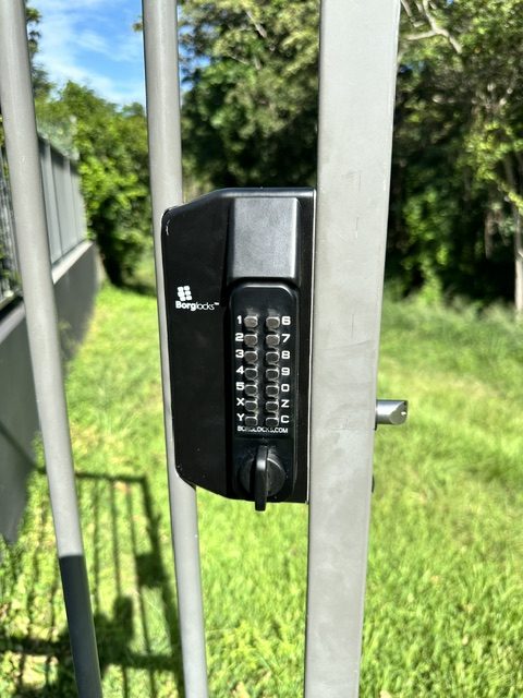 Matte black deadbolt and lever handle on a white panel door